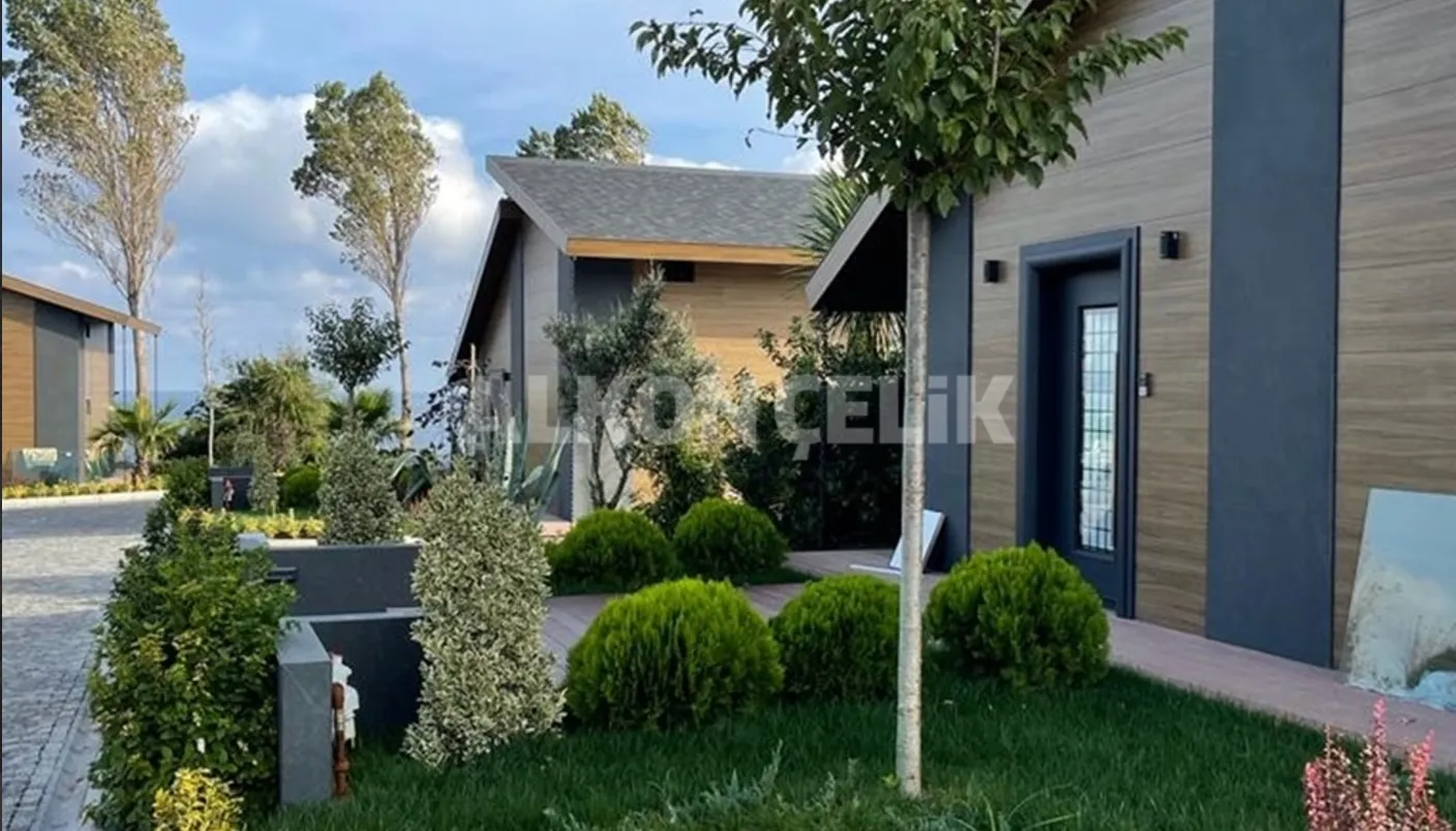 A Scandinavian-style wooden bungalow project located in a mountainous or forest setting in Europe.