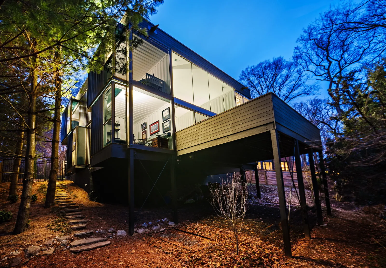A modern residence built from stacked shipping containers, showcasing an innovative and eco-friendly home design.