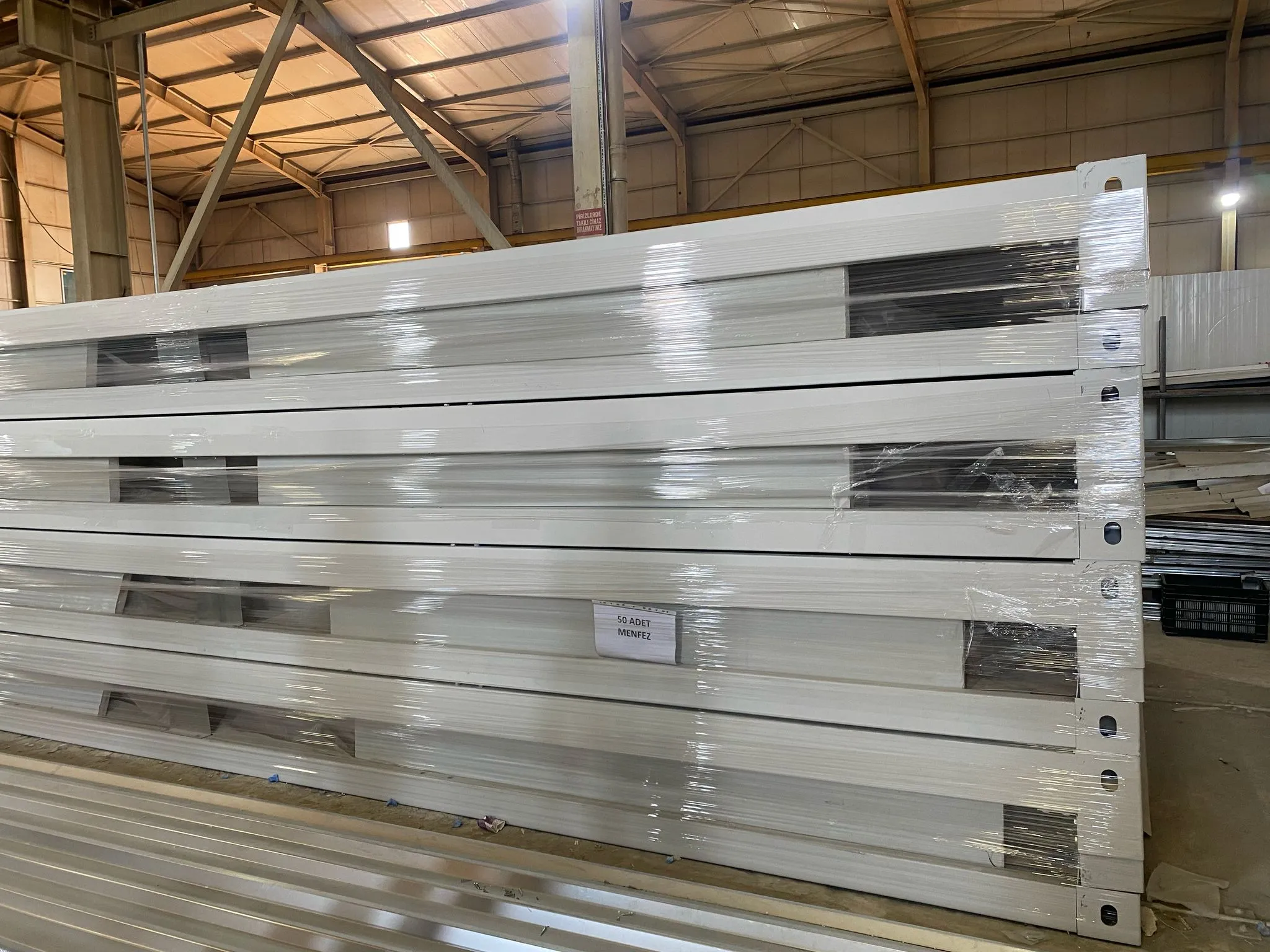 Skilled engineers performing flat pack house assembly services using light steel frames.